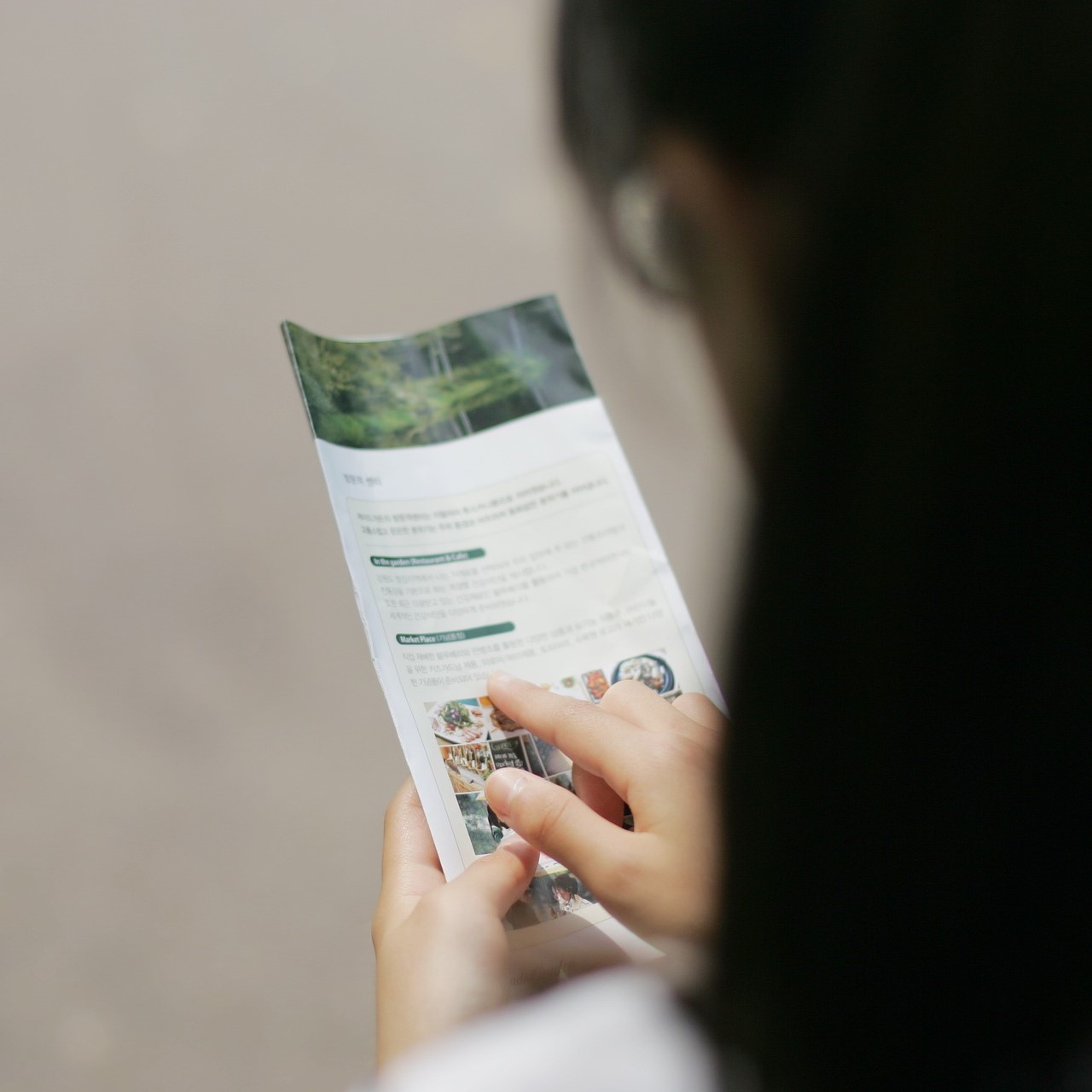 woman looking at brochure