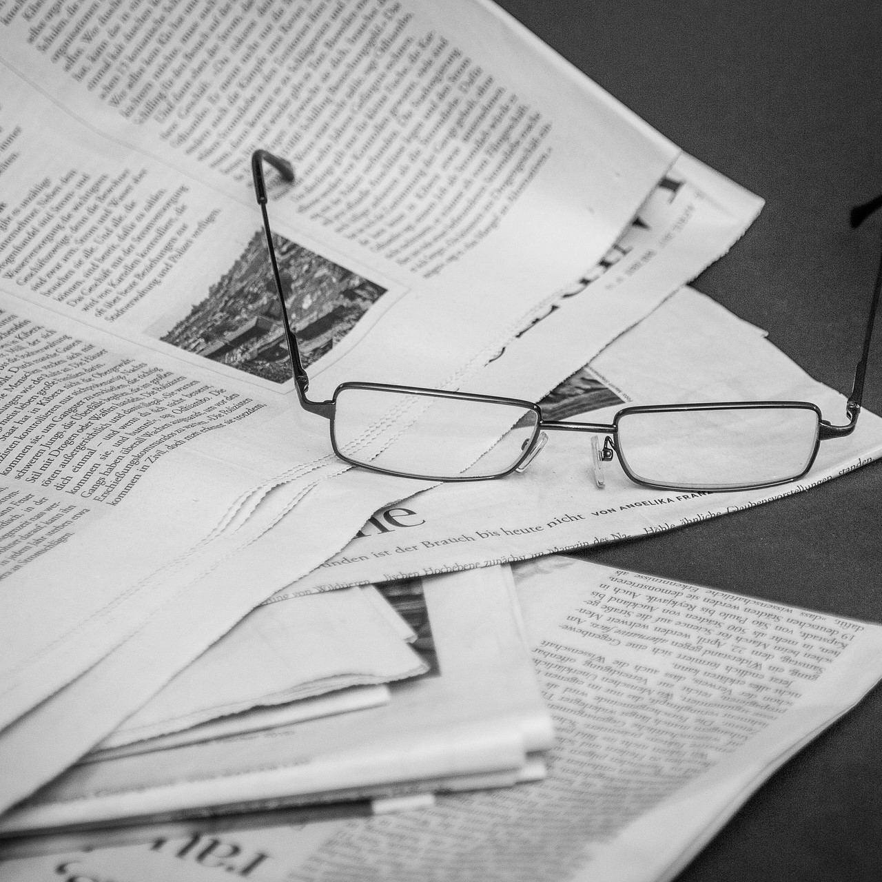 eyeglasses on a stack of papers