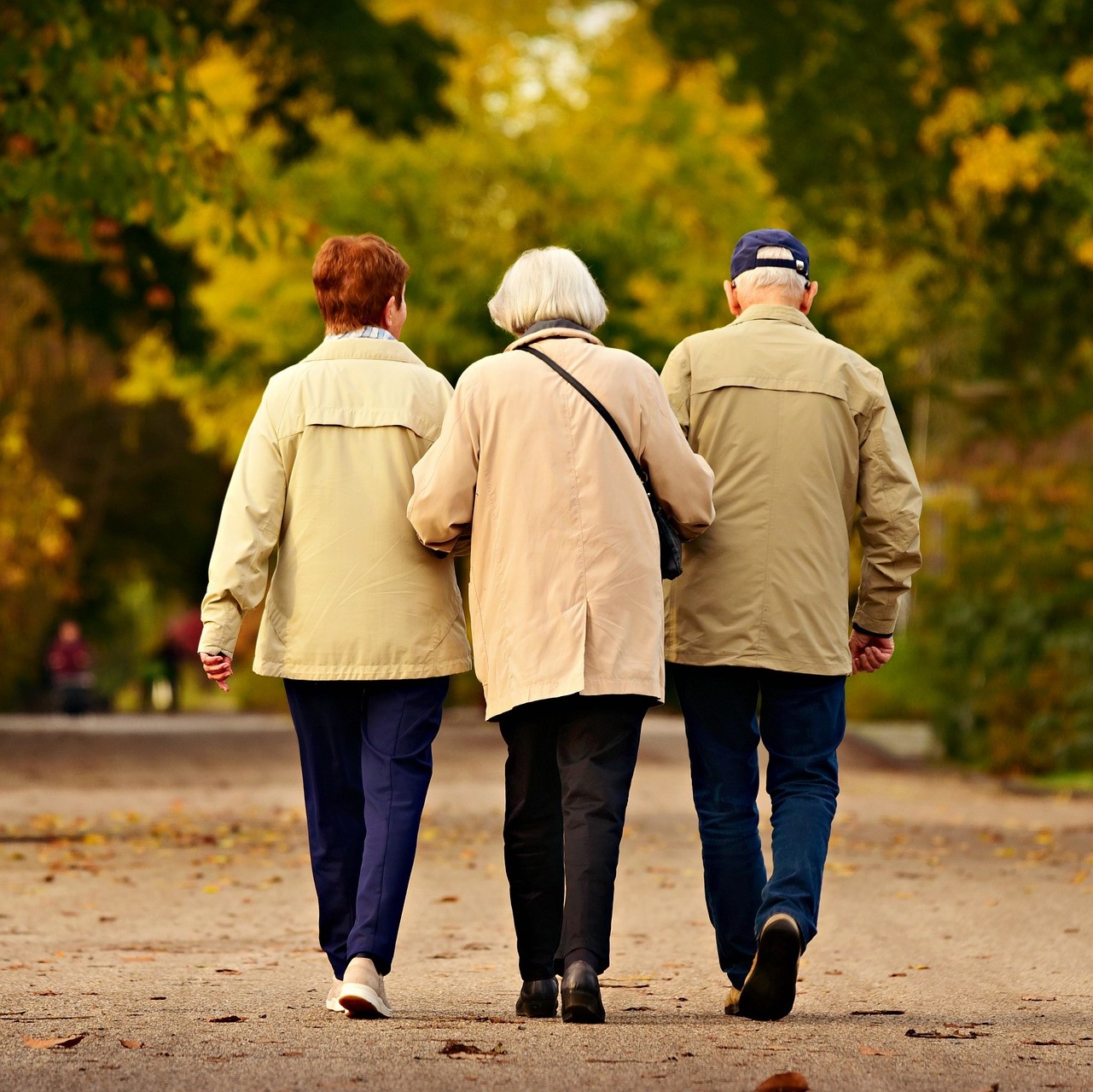 three elderly people walking